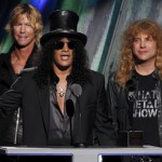 Guns N' Roses lead guitarist Slash is joined by band members Duff McKagan and Steven Adler after their induction into the Rock n' Roll Hall of Fame in Cleveland, Ohio